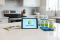 Cleaning service branding materials including Aqua Clean logo on tablet, cleaning spray bottles, microfiber cloth, scrubbing brush, and promotional brochures on kitchen countertop